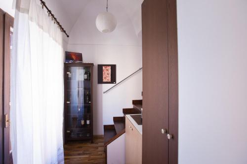 a hallway with a staircase and a stair case at Experience Il Paesino in Licodia Eubea