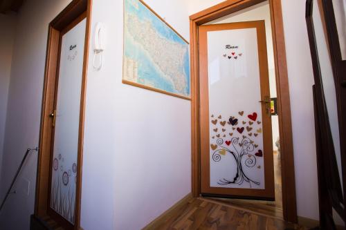a hallway with a door with a flower design on it at Experience Il Paesino in Licodia Eubea