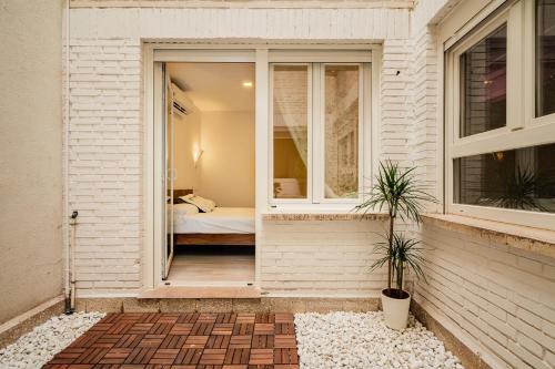 a door to a bedroom with a bed in a room at Exclusive quietness in the heart of Madrid with Public Parking, Breakfast, 2 bathrooms in Madrid