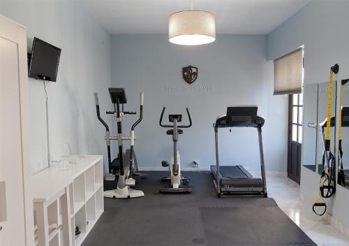 a gym with several exercise equipment in a room at Hotel Boutique Convento Cádiz in Cádiz