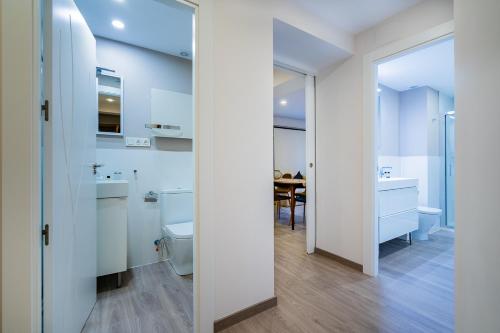a bathroom with a toilet and a sink at Exclusive quietness in the heart of Madrid with Public Parking, Breakfast, 2 bathrooms in Madrid