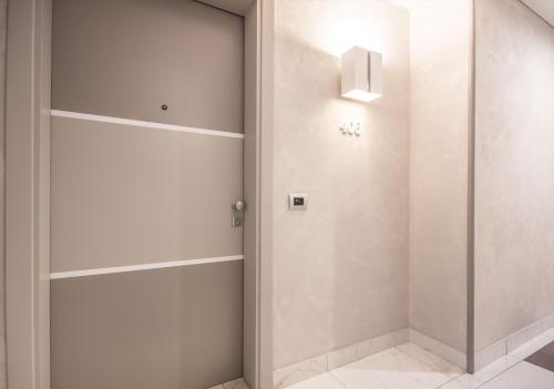 a walk in closet with white walls and a door at Best Western Modena District in Campogalliano