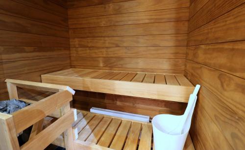 a wooden sauna with a toilet in it at Forenom Serviced Apartments Vantaa Jokiniemi in Vantaa