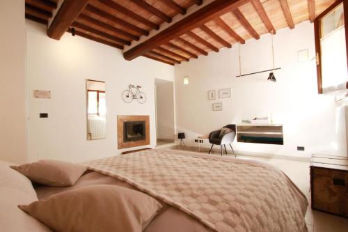 a bedroom with a large bed and a desk at La Casa nel Borgo in Monticchiello