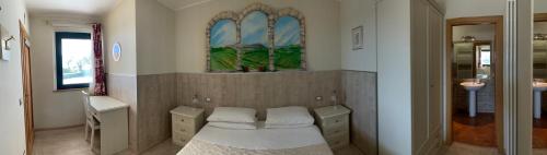 a room with a bed and some cabinets and a window at b&b DOREMI in Osimo