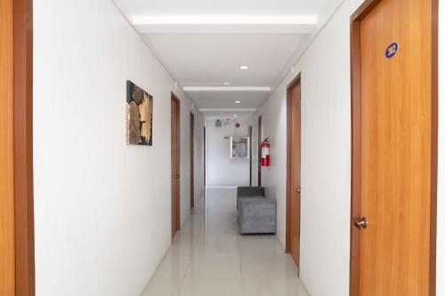 a hallway of a hospital with a chair in the middle at RedDoorz at Goldentown Hotel Davao City in Davao City