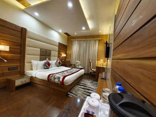 a hotel room with a bed and a desk at Hotel Makhan Residency in Amritsar