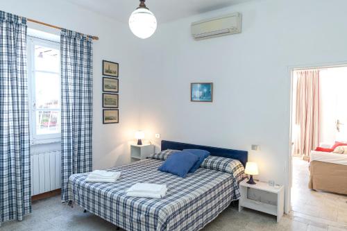 a bedroom with a bed and a couch at Fattoria Battilana in Marina di Carrara