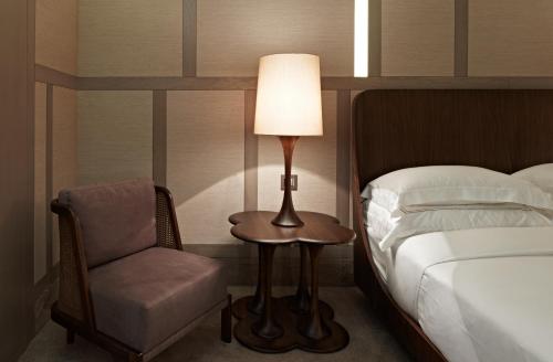 a hotel room with a bed and a lamp at The Stay Nisantasi in Istanbul