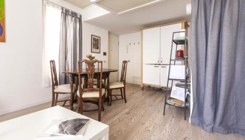 a dining room with a table and chairs at Italianway - Ripa di Porta Ticinese 17 in Milan