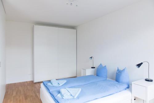 Letto o letti in una camera di HITrental Basel Apartments