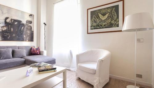 a living room with a couch and a chair at Italianway - Ripa di Porta Ticinese 17 in Milan