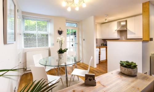a kitchen and living room with a glass table and chairs at Pottery Gate, Bowness-on-Windermere in Bowness-on-Windermere