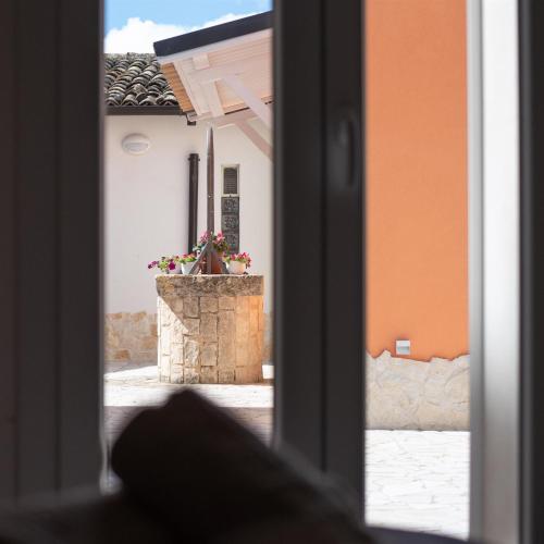 a view through an open window of a building at Dimora Villa Ada in Chiaramonte Gulfi