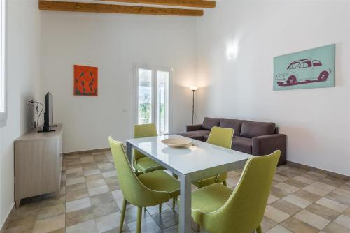a living room with a table and chairs and a couch at Dimora Villa Ada in Chiaramonte Gulfi
