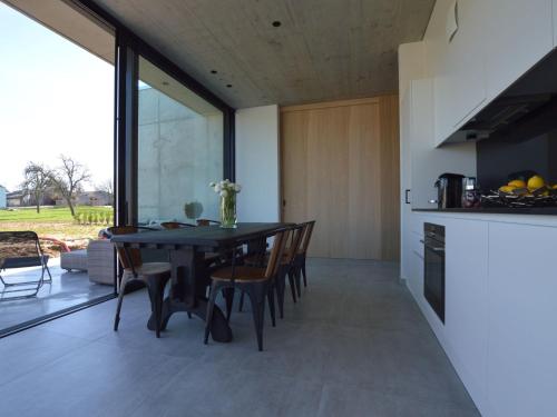 a kitchen and dining room with a table and chairs at Modern Dalhem Villa with Views in Dalhem