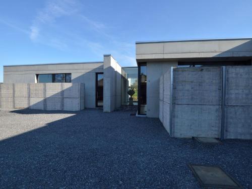 a large concrete building with a large entrance at Modern Dalhem Villa with Views in Dalhem