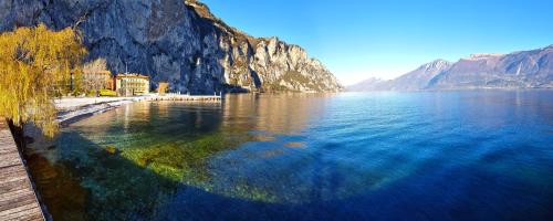 a view of a large body of water next to a mountain at Campione Splendid View by Gardadomusmea in Campione del Garda