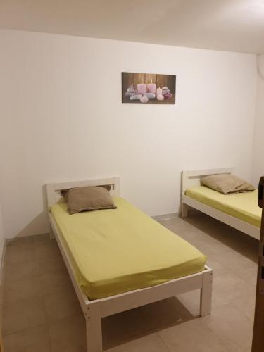 a bedroom with two beds in a room at LE GÎTE LA BLAQUIÉRE in Cendras