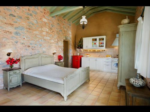 a bedroom with a white bed in a kitchen at Pandora in Pirgos Dhirou