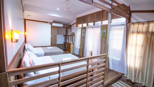 a small room with a bed and a balcony at Anjung Pantai Seberang in Kuala Terengganu