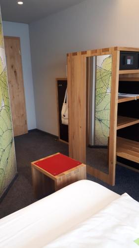a room with a bed and a mirror and a bed sidx sidx at Hotel Linde in Günzburg