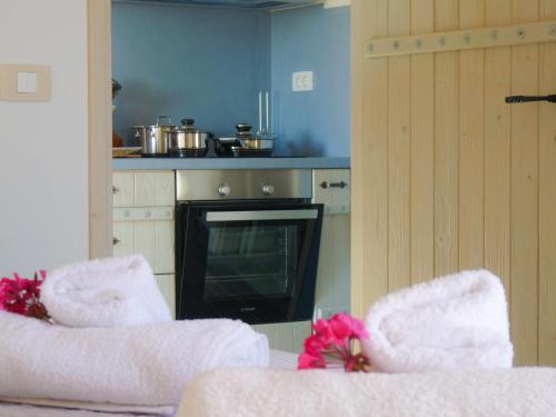 a kitchen with two white chairs and a television at Anio Residence - Rustic Modern with Sea and Mountain View Terrace in Svoronata