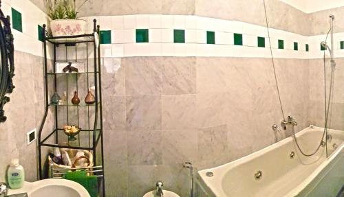 a bathroom with a shower and a tub and a sink at Campione Splendid View by Gardadomusmea in Campione del Garda