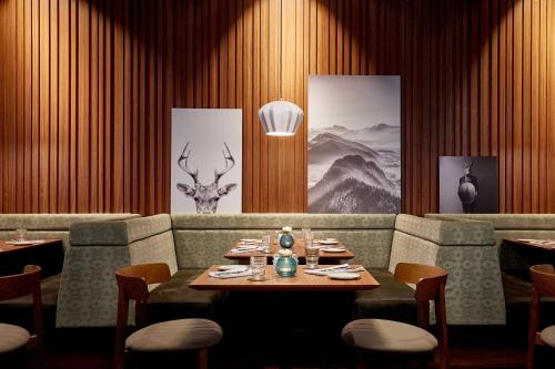 a dining room with a table and a deer head on the wall at HYPERION Hotel München in Munich