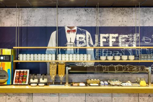 a display of food on a counter in a restaurant at ibis budget Berlin Kurfürstendamm - neu renoviert in Berlin