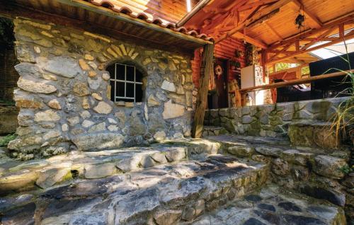 a stone house with a stone wall and a window at Kuća za odmor Bajka in Jastrebarsko