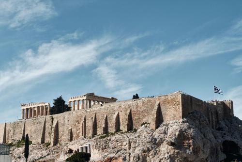 a building on top of a rocky mountain at AthensWas Design Hotel in Athens