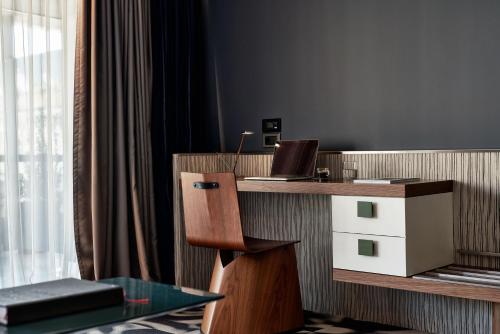 a room with a desk with a laptop on it at AthensWas Design Hotel in Athens