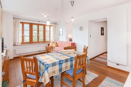 a dining room and living room with a table and chairs at Ropferhof in Telfs-Buchen