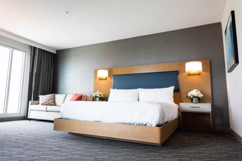 a hotel room with a large bed and a couch at Legacy Hotel at IMG Academy in Bradenton