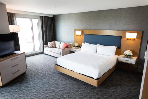 a hotel room with a bed and a television at Legacy Hotel at IMG Academy in Bradenton