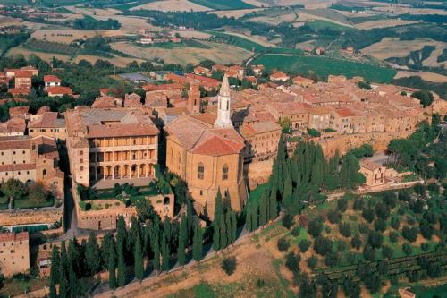 an aerial view of a large building with a church at La Casina MAG in Pienza