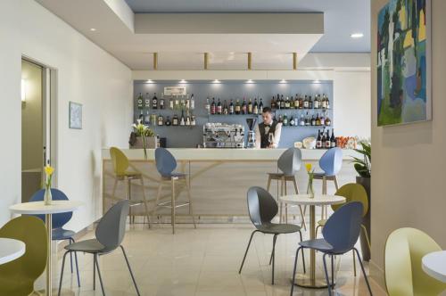 a rendering of a restaurant with tables and chairs at Grand Hotel Pietra Ligure in Pietra Ligure