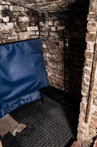 a blue bed sitting in a brick wall at Brighton Erotic Boudoir in Brighton & Hove