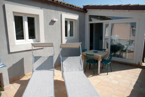 a patio with a staircase and a table and chairs at 4 Elements Boutique Home in Siracusa