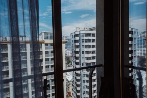 a window view of a city with tall buildings at Aparthotel Tangerine in Batumi