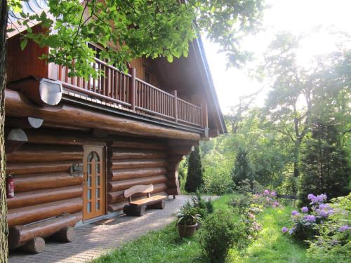 a log cabin with a porch and a balcony at Naturtraum Georgshöhe in Thale