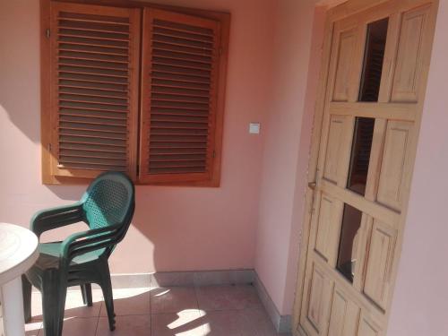 a room with a table and a chair and a window at Víziszony üdülő in Mindszent