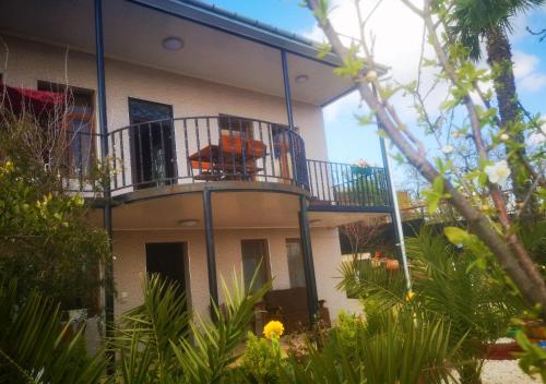 a building with a balcony with two chairs on it at Hostel Sadu Kutaisi in Kutaisi