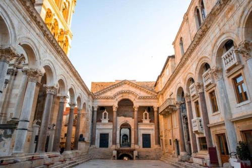 a large building with a courtyard in the middle at Diocletian Studio Apartments in Split