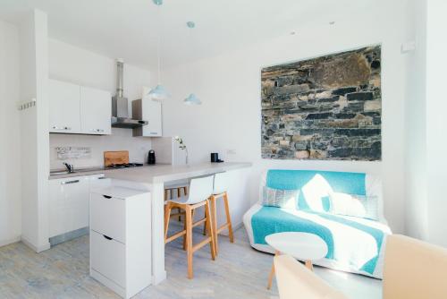 a bedroom with a bed and a kitchen with a desk at "Gioiello Vista Lago" Moltrasio Lake Como in Moltrasio