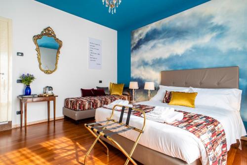 a bedroom with a large bed and a couch at Bibliò Rooms Guesthouse in Bologna