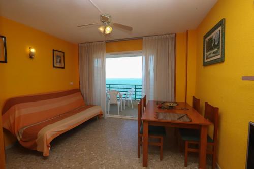 a bedroom with a bed and a desk and a window at COSTA DAURADA APARTAMENTS - Paradis 704 in Salou