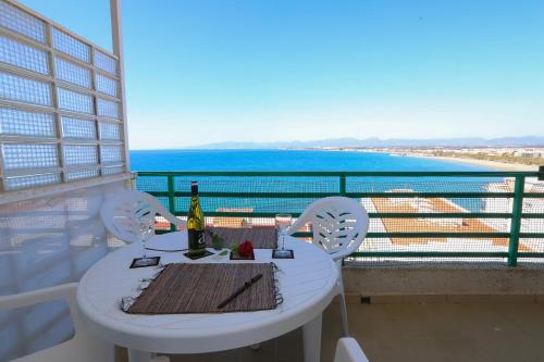 a white table and chairs with a view of the ocean at COSTA DAURADA APARTAMENTS - Paradis 704 in Salou