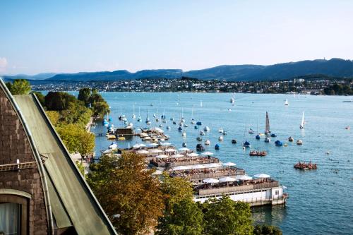 a large body of water with boats in it at La Réserve Eden au Lac Zurich in Zürich